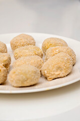 Handmade falafel balls ready to cook. Plate prepared with raw falafel is half finished fod. Meatless vegetarian food.