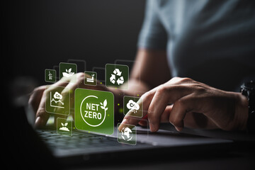 Young woman using laptop with net zero 2050 carbon neutral environment icon. Long-term,...