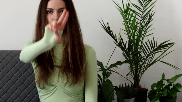 A beautiful young woman psychiatrist points her fingers at the Desensitization and Eye Movement EMDR method.