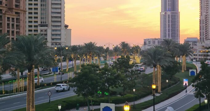 Rush hour traffic at a junction on the road in Doha, Qatar at sunset