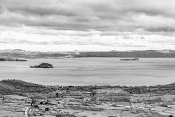 Panoramic black and white view of Lake Bolsena from Montefiascone, Italy, including the islands