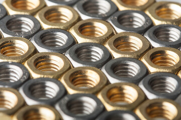 Metallic hex nuts layed out in a hexagonal pattern