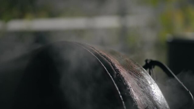 Steam evaporation out of a copper boiler in homemade distillery. Making moonshine schnapps, alcoholic beverages such as brandy, cognac, whiskey, bourbon, gin, and scotch, slow motion