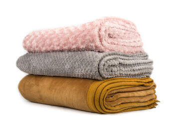 Folded blankets on a white background