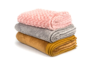 Folded blankets on a white background