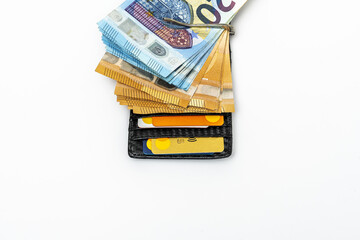 a male wallet with debit cards and many euros