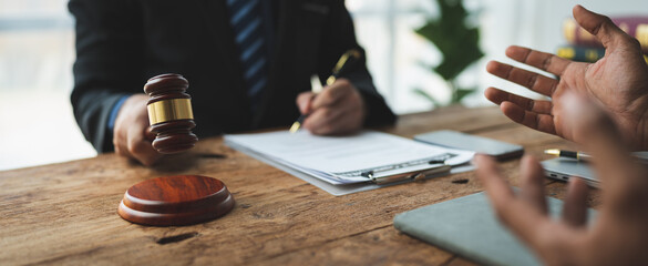 Lawyer or judge holding Hammer prepares to judge the case with justice, and litigation, scales of justice, law hammer, Legal consulting services, Concept of litigation, and legal services.