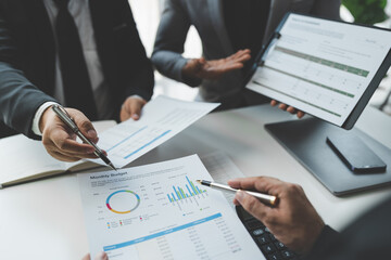 Businessman discussing with colleague plan analyzing financial data charts and graphs. sales strategy Calculate a numerical balance sheet from papers at successful meetings and teamwork.