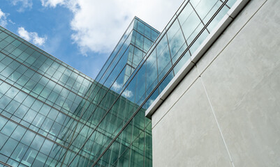 Modern sustainable glass office building. Exterior view of corporate headquarters glass building...