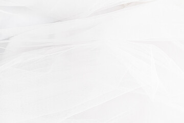 Fototapeta premium The soft folds of the veil of the bride's traditional wedding accessory. Wedding background. layout for design.