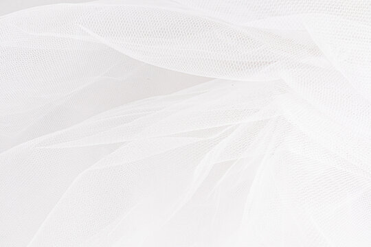 Delicate texture of the background. Elegant soft tulle fabric. Bridal wedding foil close-up for design, plase for text.