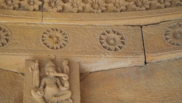Closeup shot of carvings on the top portion of the chattri dome cenotaph at Bada Bagh in Jaisalmer, Rajasthan, India. Carvings on top of the structure made out of sandstone. Ancient carving on dome. 