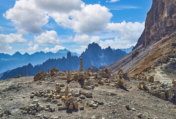 Stones gravel stack bellow Alpine mountain summit. Spring trail around Tre Cime di Lavaredo, well known also as Drei Zinnen , Dolomite Alps, Italy.