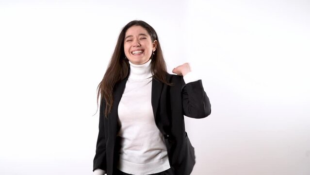 Smartly dressed happy looking young woman with dark hair going through a range of positive emotions while using highly expressive body language Generative AI