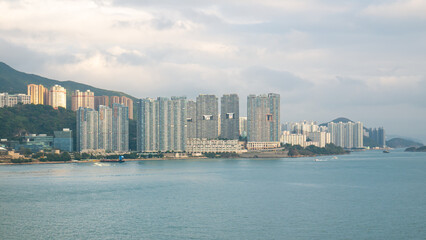 View of Hong Kong Island living quarter cityscape with many skyscraper buildings from sea.