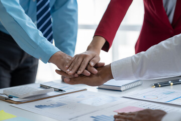 A group of business people working together to complete a task Hands clasped as a symbol of unity and teamwork. Meeting, startup. Modern business concept.