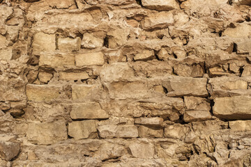 Stone wall from partially destroyed old masonry