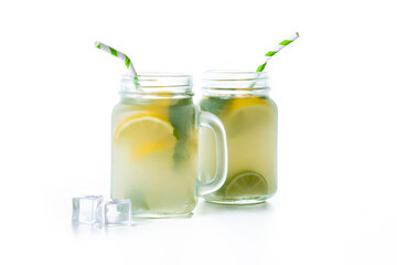 Lemonade drink in a jar glass and ingredients isolated on white background