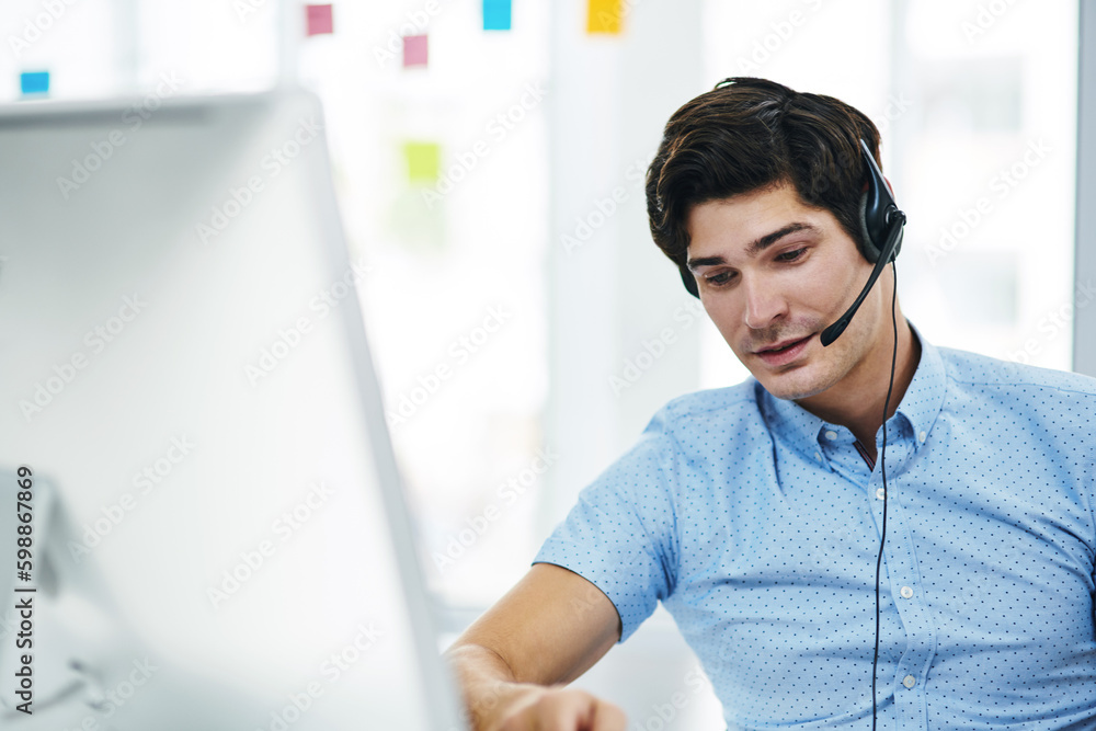 Aufkleber Ill sort it all out for you. a young businessman using a headset while working on a computer in an office.