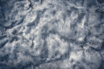 Background of white dirty cotton wool from old matress stuffing close up top down view