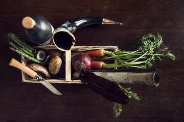 Fresh vegetables and travel artefacts in basket