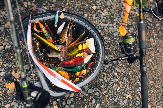 Fishing gear in bucket and fishing rods