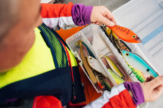 Close-up of man holding fishing lures