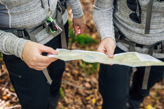 Close-up of two hikers holding map