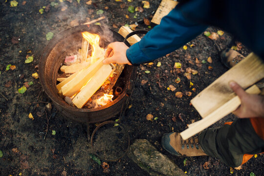 Hiker making fire in forest