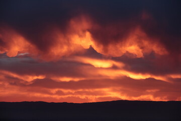 Fototapeta na wymiar beau coucher de soleil sur la plaine dans les tons rouges orangés
