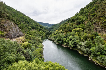 View of the village of Os Peares, Ourense, Galicia in Spain, where the Sil and Mino rivers converge. - obrazy, fototapety, plakaty