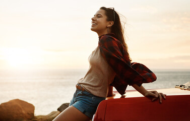 The heart is happiest when its free. a happy young woman enjoying a summers road trip.