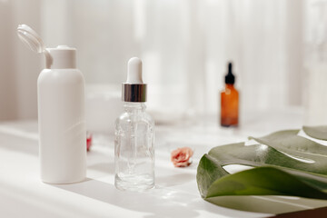 Glass jars with oil and extracts on white table. Making fragrance