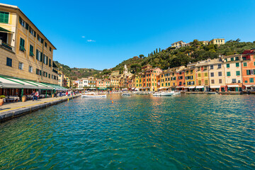 Fototapeta na wymiar Port and cityscape of Portofino, luxury tourist resort in Genoa Province, Liguria, Italy, Europe. Colorful houses, Mediterranean sea (Ligurian sea).