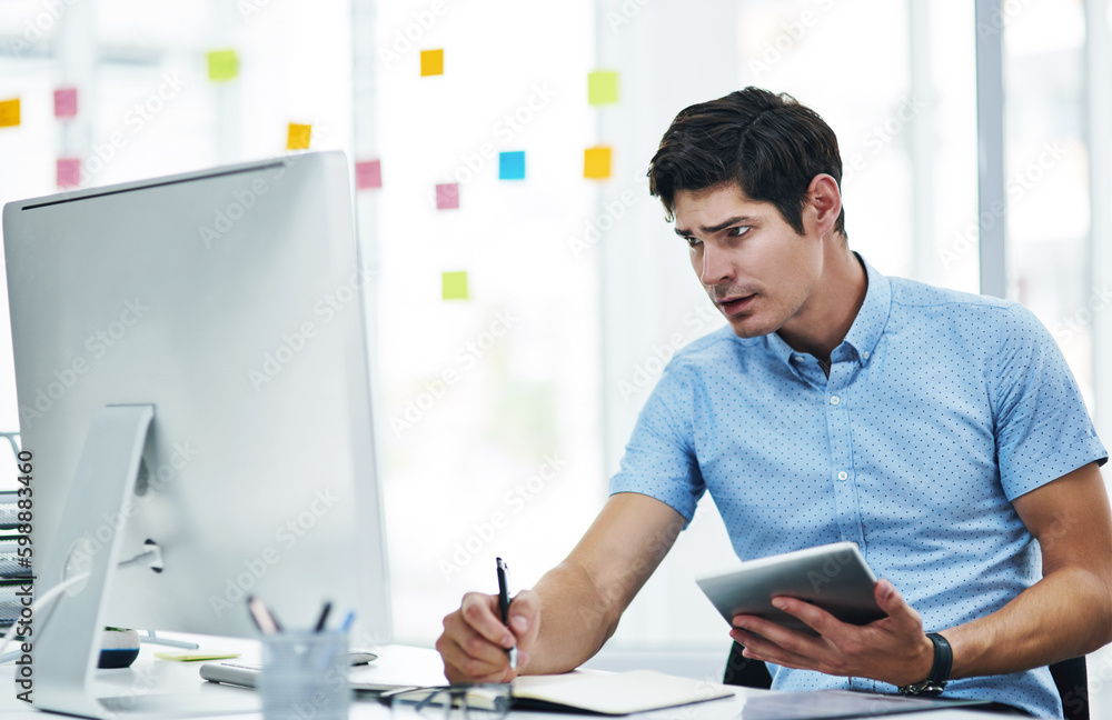 Poster Pulling out all his resources to get the job done. a young businessman writing notes while using a digital tablet and computer in an office.