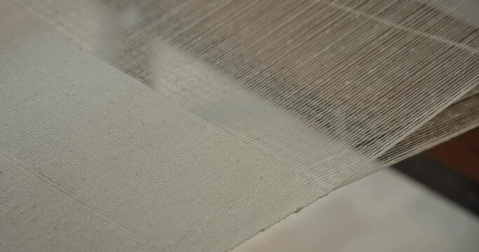 close up of organic cotton textile being produced on a handloom