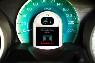 Low battery warning light on black screen instrument panel of EV electric vehicle, Electric car technology concept.