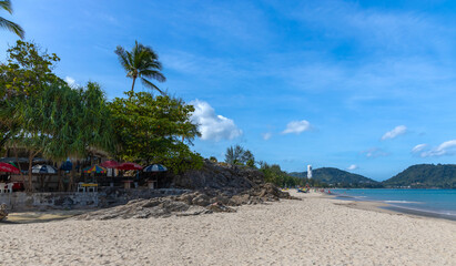 Patong Beach Phuket Thailand nice white sandy beach clear blue and turquoise waters and lovely blue skies with Palms tree