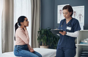 Fototapeta premium My throat is a bit scratchy. a young female doctor writing down a patients information in an office.
