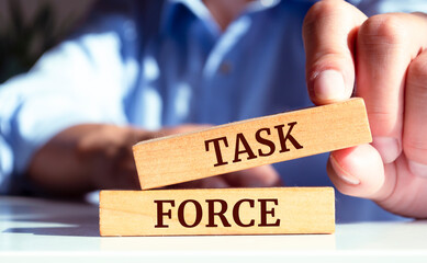 Close up on businessman holding a wooden block with a 