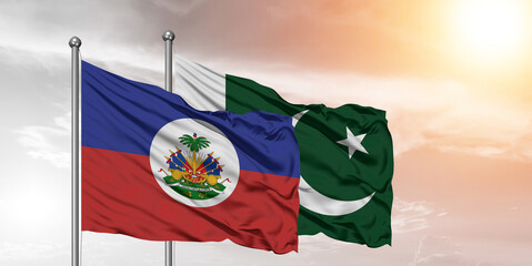Flags of Pakistan and Haiti friendship flag waving on the sky with beautiful Background.