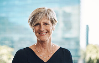 Fototapeta premium Life feels good when you face your goals. Portrait of a confident mature businesswoman against a city background.