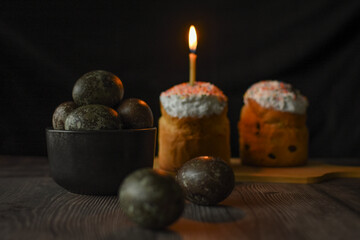 Fototapeta na wymiar colored eggs,a festive cake and a burning church candle