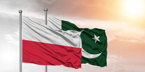 Flags of Pakistan and Poland friendship flag waving on the sky with beautiful Background.