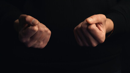 Two human fists isolated on black background
