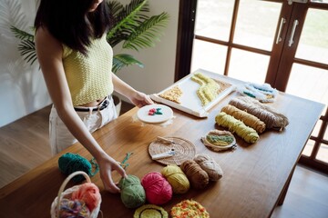 Punch needle. Asian Woman making handmade Hobby knitting in studio workshop. designer workplace...