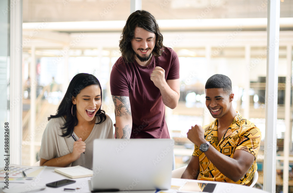 Canvas Prints Emerging victorious yet again. a group of businesspeople cheering while working together on a laptop in an office.