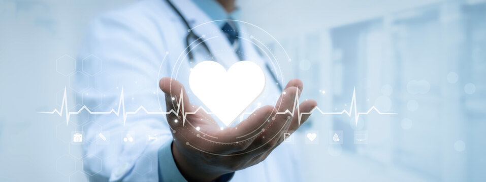 Doctor hold white heart of medical with healthcare icons on virtual interface network. Virus pandemic develop people awareness healthcare, Science, Medical technology and health care service