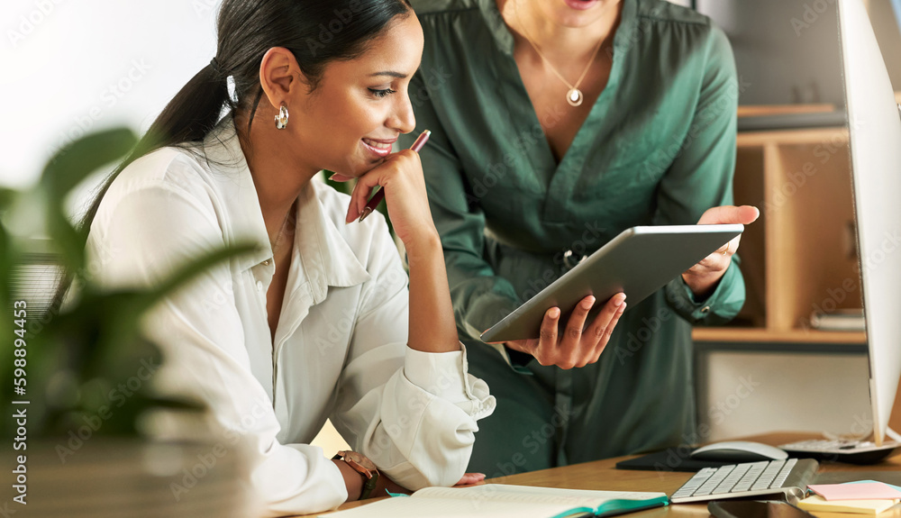 Poster can we go ahead with the data. two businesswomen using a digital tablet to oversee work.