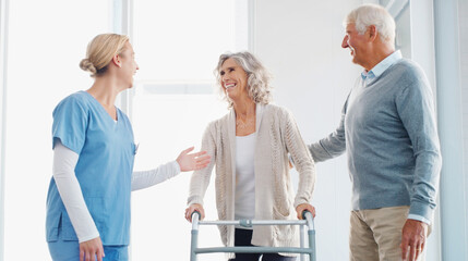 Support that makes a world of difference. a senior woman using a walker with the assistance of her...